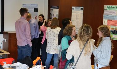 Students discussing posters at the Insights Festival
